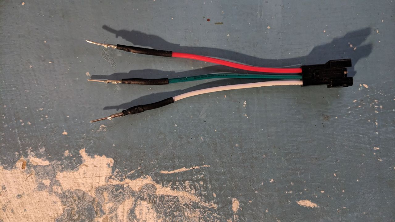 A crimped three-pin connector for a neopixel strip